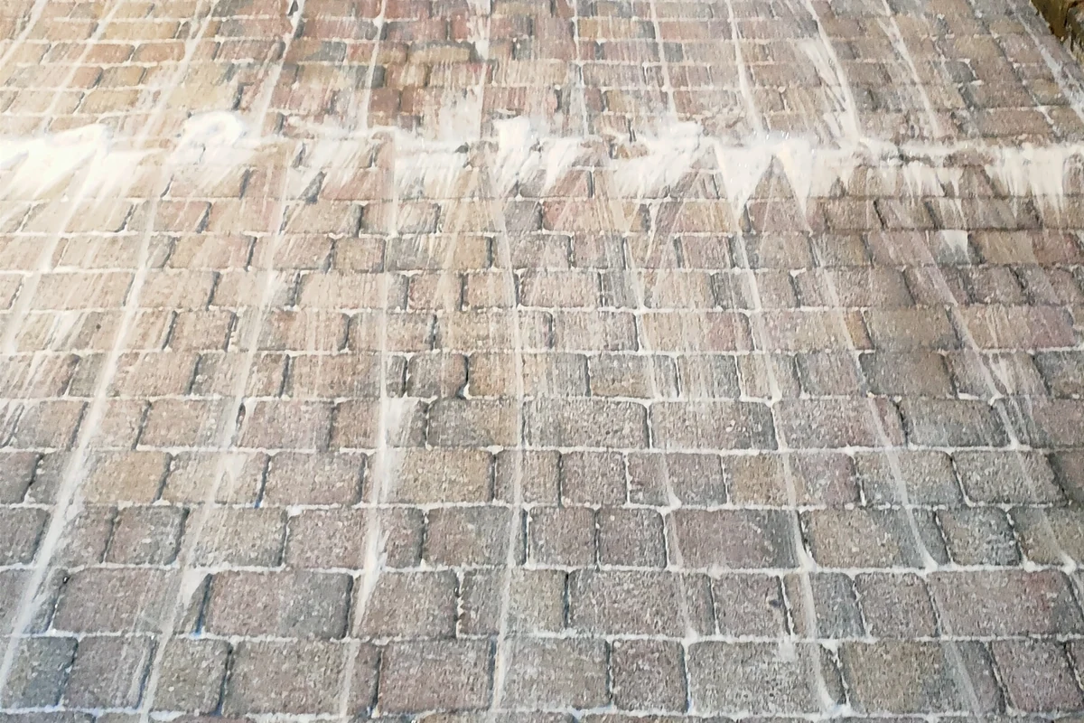 Specialist algae treatment applied to driveway surface by Exact Clean