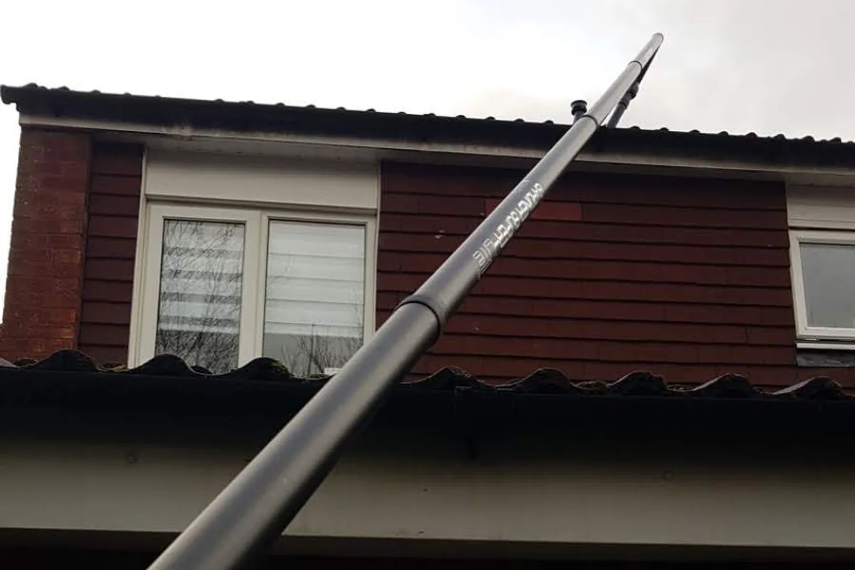 Residential gutter cleaning in progress by Exact Clean