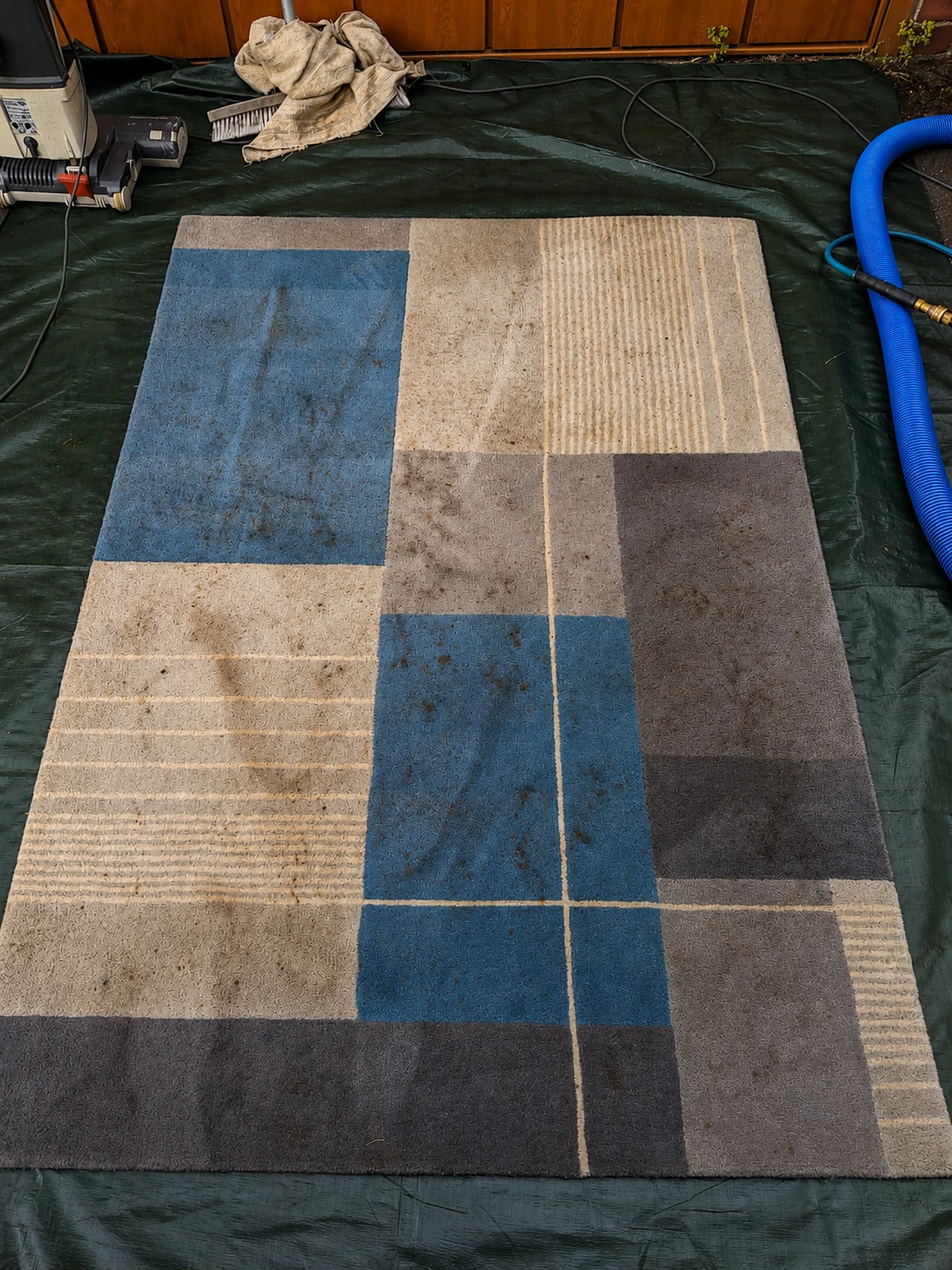 Residential rug before professional cleaning by Exact Clean showing visible soil and debris